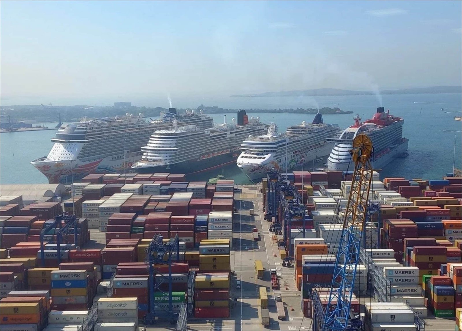 Cruise ships docked beside stacked shipping containers at the Port of Cartagena